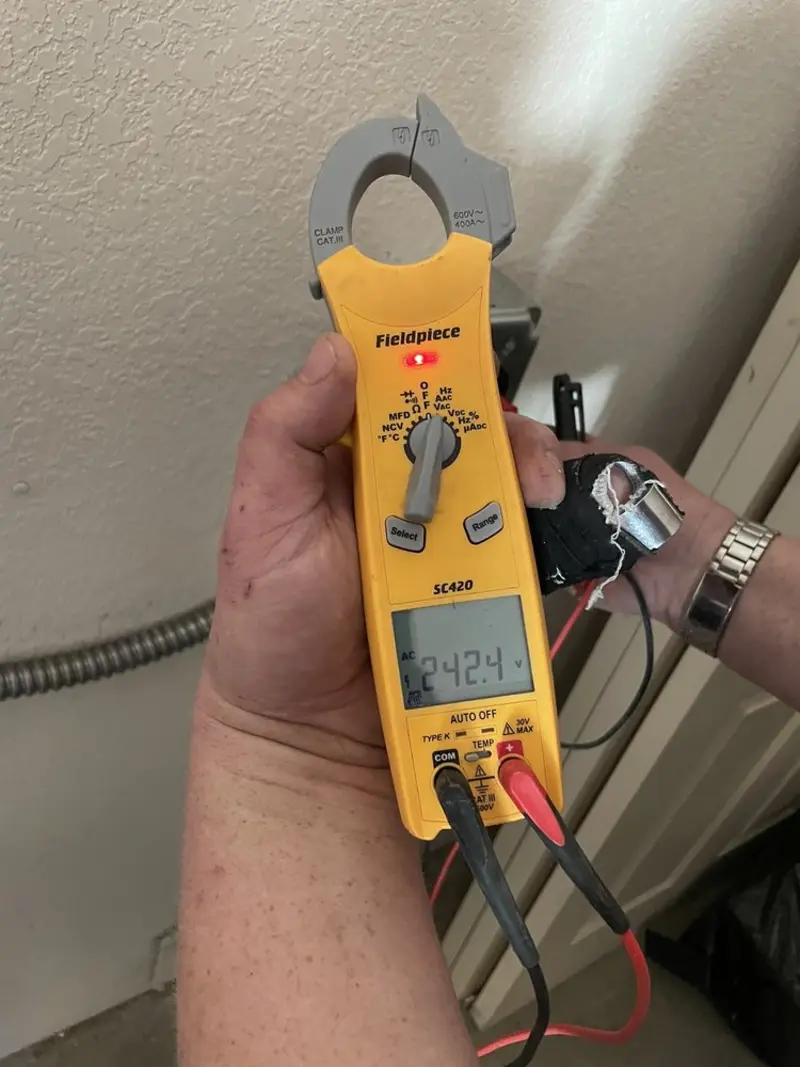 Voltage testing with clamp meter during Recessed Lighting Installation in Prosser